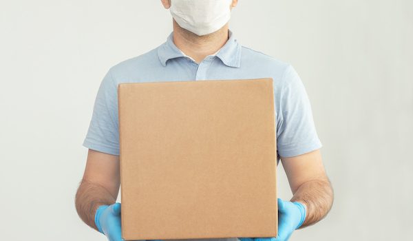 delivery man holding cardboard box